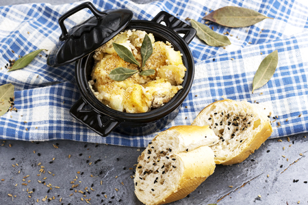 homemade arabic food gratin of potato and cheese and meat with sliced of breadの写真素材