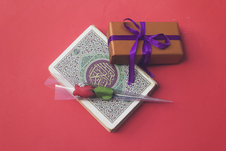 holy book of Muslims quran and present, rose flower for muslim holidayの写真素材
