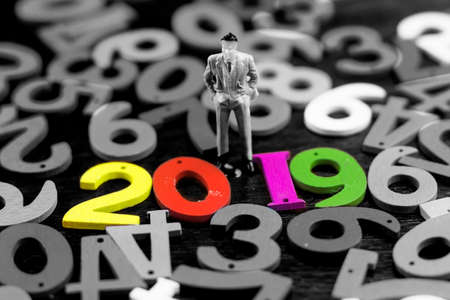 business man stand up and colorful numbers with new year conceptの写真素材