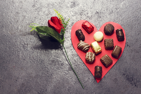 various chocolate on paper red heart shape and red flower for valentine's dayの写真素材
