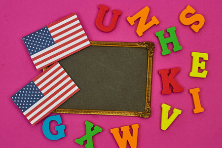 usa flag card with frame photo and alphabets on pink background. Concept of English language coursesの写真素材
