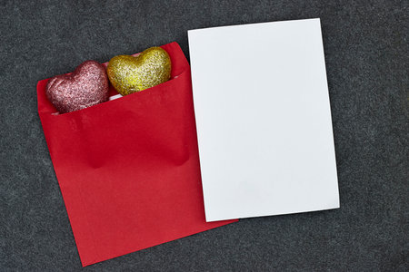 Wedding invitation card mockup and red envelope with yellow and pink heart toy glitter. Blank card...
