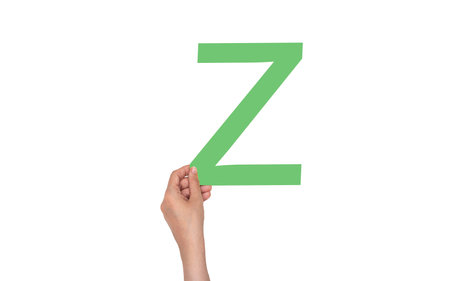 closeup hand holding paper letter Z  isolated on whiteの写真素材