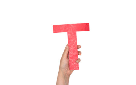 closeup hand holding paper letter T isolated on whiteの写真素材