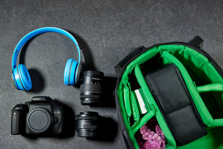 Professional Photography Gear : camera and lenses, blue wireless headphone on grunge gray backgroundの写真素材