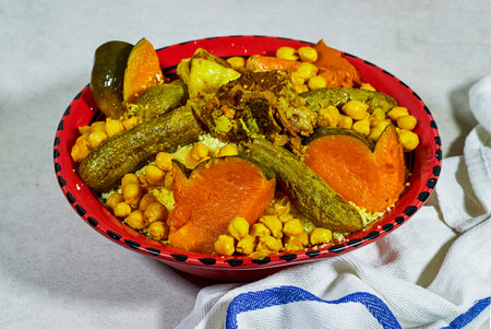Meat and vegetable couscous in a tajine plate, typical food from Algeria, a traditional festive Arabic dish with herbs and spicesの写真素材