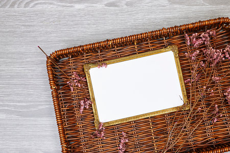 golden picture or photo frame mockup with pink baby's breath, gypsophila on esparto halfah backgroundの写真素材