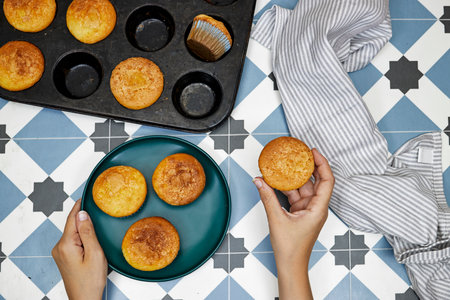 Pan Vanilla Caramel Nuts Muffins In Paper Cups and hand hold one piece