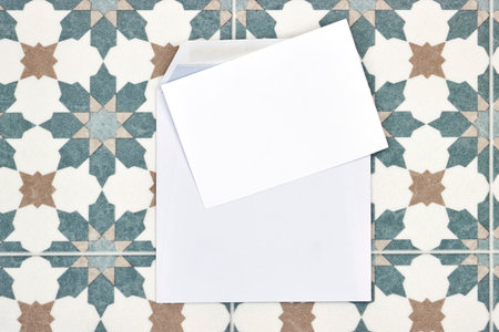 Wedding invitation card mockup and white envelope on seamless floral Algerian background. Blank card mockupの写真素材