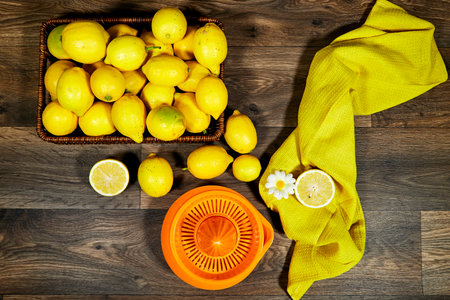 halfah basket full of lemons on wood table with plastic squeeze, Gardening concept, lemonadeの写真素材