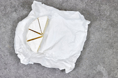 Top view, sliced round white cheese camembert - a traditional dairy creamy dairy product on plasticの写真素材