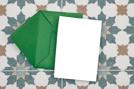 Wedding invitation card mockup and green envelope on seamless floral Algerian background. Blank card mockupの写真素材
