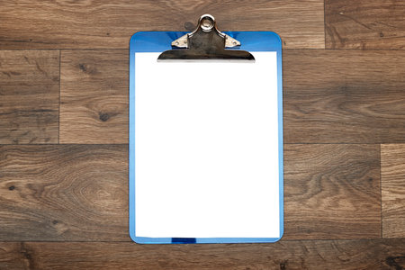 Classic metal clipboard with blank white paper on wood tableの写真素材