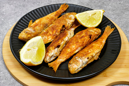 Delicious grilled red mullet fish with garnishes like lemon