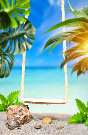 Wooden swing on a beach for putting your product. Relaxing, peaceful vacation scene at the beachの写真素材