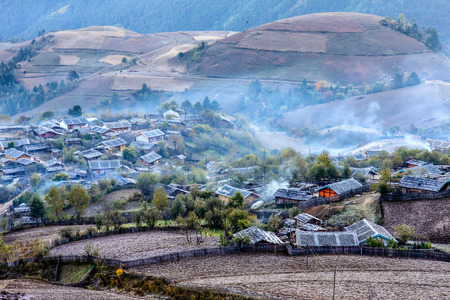 Foggy morning autumn landscape and village in Yunan,China.の写真素材