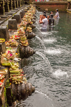 Bali, Indonesia, April 21,2010 : Balinese people praying at holy spring water temple Pura Tirtha Empul during purification ceremony  in Tampak Siring, Bali, Indonesia.のeditorial素材