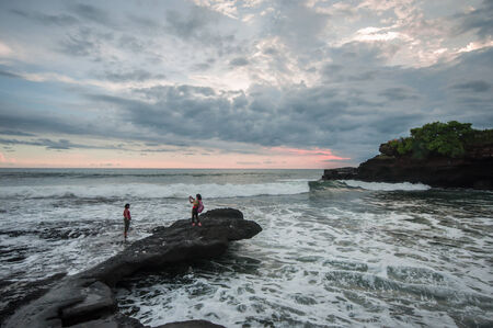 Bali, Indonesia, April 22,2010 : Tourist take picture at Tanah Lot beach in Bali,Indonesia.the popular place in Bali.のeditorial素材
