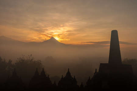 Merapi volcano on sunrise viewing from Borobudur Temple(silhouette scene)の写真素材
