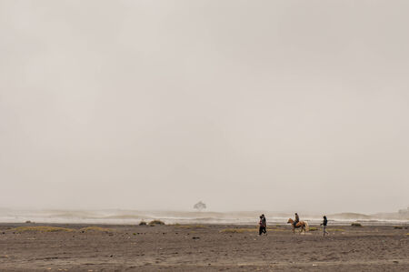Java,Indonesia-Arpil 25,2010 : Indonesia man with the horse for tourist rent at Mount Bromo in Java , Indonesia.Mt. Bromo is an active volcano and part of the Tengger massif, in East Java.のeditorial素材
