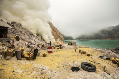Kawah Ijen, Indonesia - April 24,2010 :  Workers extracting sulfur inside Ijen crater  in Ijen Volcano, Indonesia. He carries the load of around 60kg to the top of the rip and then 3km down.のeditorial素材