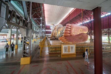 Yangon, Myanmar - March 13, 2011: The tourists visiting Chauk htat gyi reclining buddha (sweet eye buddha), in yangon, myanmarのeditorial素材