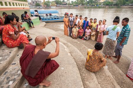 Yangon, Myanmar - March 14, 2011: Myanmar people and Myanmar monk visiting Yele Phaya and take photo near river(Pagoda on a small island of river) in Syriam, Myanmar.のeditorial素材