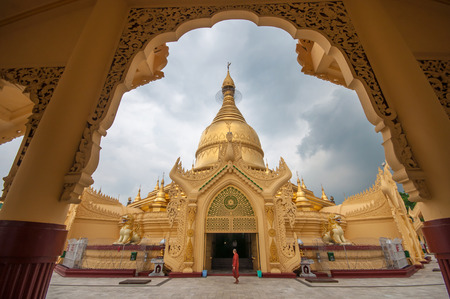 Yangon, Myanmar - March 14, 2011: The Myanmar monk walking around the Maha Wizaya Paya pagoda, near...
