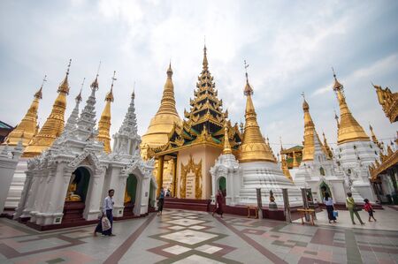 Yangon, Myanmar - March 14, 2011: People visiting Shwedagon Pagoda before sunset in Yangon of Myanmar. It is the most sacred Buddhist pagoda for the Burmese with relics of the past four Buddhas enshrined within.のeditorial素材