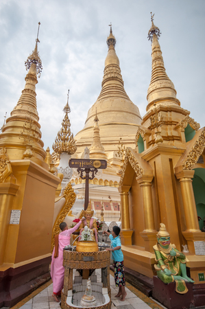 Yangon, Myanmar - March 14, 2011: People visiting Shwedagon Pagoda before sunset in Yangon of Myanmar. It is the most sacred Buddhist pagoda for the Burmese with relics of the past four Buddhas enshrined within.のeditorial素材