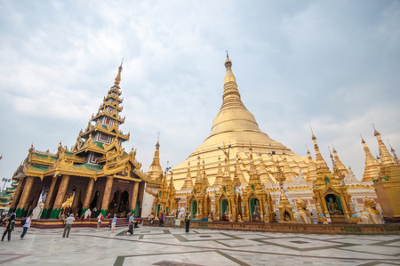 Yangon, Myanmar - March 14, 2011: People visiting Shwedagon Pagoda before sunset in Yangon of Myanmar. It is the most sacred Buddhist pagoda for the Burmese with relics of the past four Buddhas enshrined within.のeditorial素材