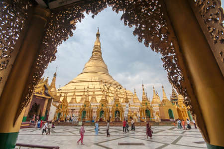 Yangon, Myanmar - March 14, 2011: People visiting Shwedagon Pagoda before sunset in Yangon of Myanmar. It is the most sacred Buddhist pagoda for the Burmese with relics of the past four Buddhas enshrined within.のeditorial素材