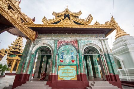 Yangon, Myanmar - March 14, 2011: Myanmar monk siting in temple of Shwedagon Pagoda  in Yangon of Myanmar. It is the most sacred Buddhist pagoda for the Burmese with relics of the past four Buddhas enshrined within.のeditorial素材