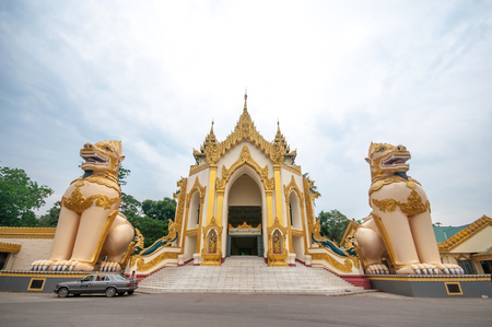 Yangon, Myanmar - March 14, 2011: People visiting at entrance of Shwedagon Pagoda before sunset in Yangon of Myanmar. It is the most sacred Buddhist pagoda for the Burmese with relics of the past four Buddhas enshrined within.のeditorial素材