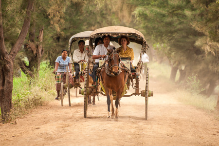 Inwa,Myanmar-March 16,2011 : Unidentified carriage of passengers and carrying supplies the highway...