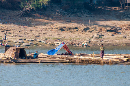 Bagan,Myanmar-March 17,2011 : Unidentified Myanmar people on bamboo floating in Irrawaddy river  in Bagan,Myanmar.のeditorial素材