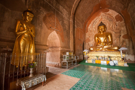 Bagan,Myanmar-March 18,2011: The Buddha image inside  Gubyauknge  temple  in Bagan, Myanmar.one of the famous tourist spots in Bagan.The Temple is an ancient architecture of AD 11th Century, built earlier than the Wetkyi-in Gubyaukgyi.のeditorial素材