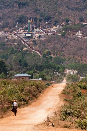 Pindaya, Myanmar - March 20,2011:Burmese man walking to Pindaya natural caves, Myanmar,located in the hills of the Shan State ,are a Buddhist pilgrimage site and a tourist attraction.のeditorial素材