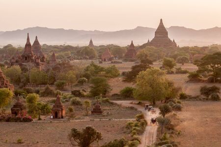 Bagan,Myanmar-March 18,2011: Sunset view plain of temple with horse carriages at Bagan ancient city located in the Mandalay Region of Burma, Myanma.のeditorial素材