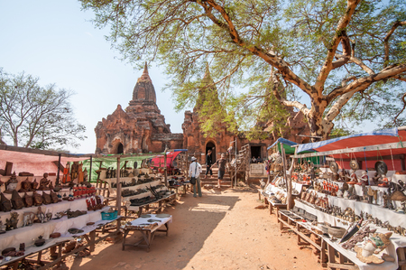 Bagan,Myanmar-March 19,2011 : Nagayon Temple entrance with tourist  passing by street market to enter the temple in Bagan,Myanmar.のeditorial素材