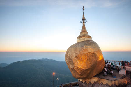 Kyaiktiyo,Myanmar-March 22,2011: Myanmar People praying and used gold leaf to pay homage and worship at Kyaikhtiyo pagoda,That sits atop Mount Kyaiktiyo is one of the most sacred sites  in Kyaikhtiyo of Mon state in Myanmar.のeditorial素材