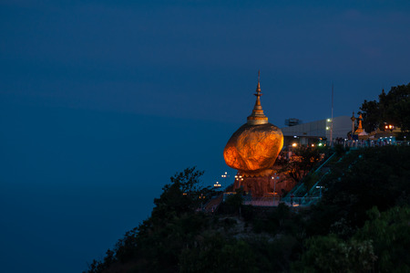 Kyaiktiyo,Myanmar-March 23,2011: Myanmar People praying and used gold leaf to pay homage and worship at Kyaikhtiyo pagoda at night,That sits atop Mount Kyaiktiyo is one of the most sacred sites  in Kyaikhtiyo of Mon state in Myanmar.The pagoda is 1100km aのeditorial素材
