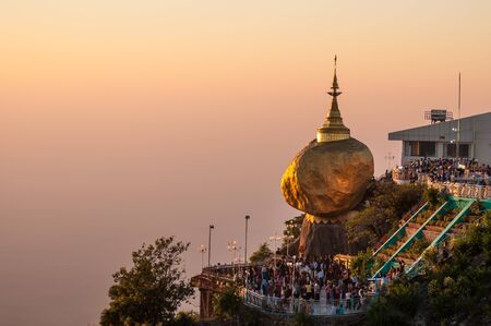 Kyaiktiyo,Myanmar-March 22,2011: Myanmar People praying and used gold leaf to pay homage and worship at Kyaikhtiyo pagoda,That sits atop Mount Kyaiktiyo is one of the most sacred sites  in Kyaikhtiyo of Mon state in Myanmar.のeditorial素材