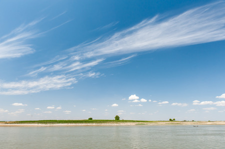 River  landscape with clouds and blue sky in summer