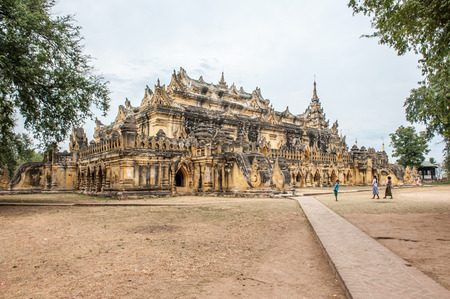 InwaMyanmarMarch 162011 : Tourist visit  Maha Aung Mye Bon Zan Monastery well known as Me Nu Oak Kyaung or the Brick Monastery was built by Nanmadaw Me Nu Chief Queen of King Bagyidaw in 1818 in Inwa ancient cityMandalay StateMyanmar.のeditorial素材
