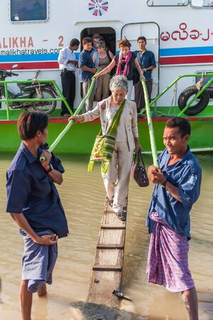 Bagan,Myanmar-March 17,2011 : The tourists walk out ferry boat when arrival Bagan at Bagan harbor on the bank of the Irrawaddi river in  in Bagan, Myanmar.のeditorial素材