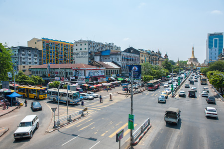 Yangon, Myanmar - March 24,2011: Traffic in downtown Yangon  in Yangon, Myanmar or Burma. In the middle of a roundabout, stands the Sule Pagoda, a religious and historic siteのeditorial素材