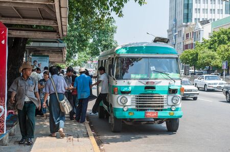 Yangon, Myanmar - March 24,2011: Unidentified people get off a local bus  in Yangon, Myanmar. Yangon...