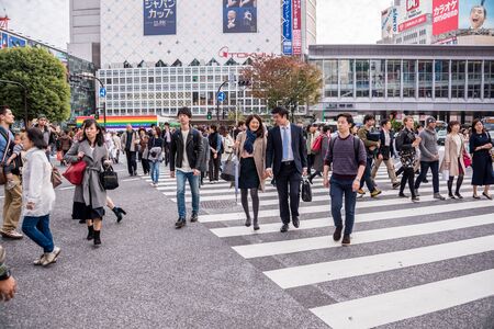 Tokyo, Japan - November 21, 2015: Unidentified pedestrians walk at Shibuya Crossing, one of the...