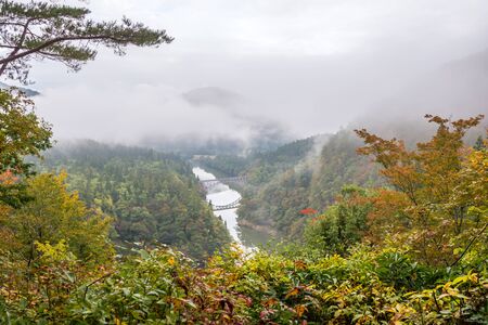 First bridge and Tadami river in beautiful autumn season in Japanの写真素材